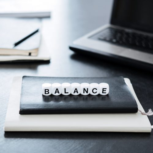 Balance in Accounting. Word Balance on background of laptop and calculator in office.